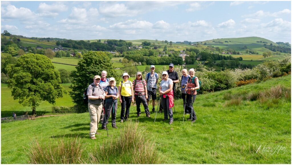 A group of walkers in a grassy meadow on a sunny day