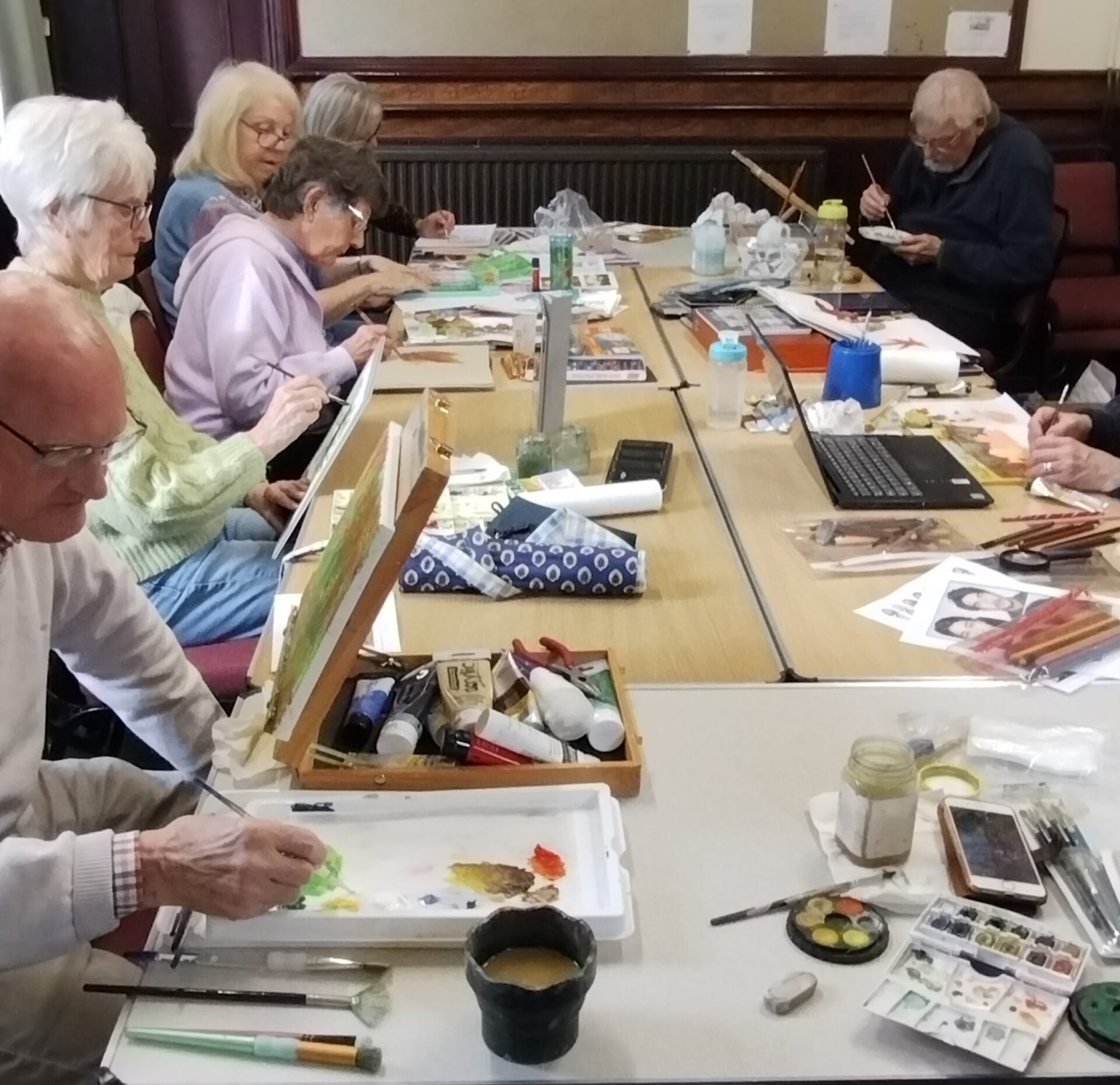Art group members working at tables