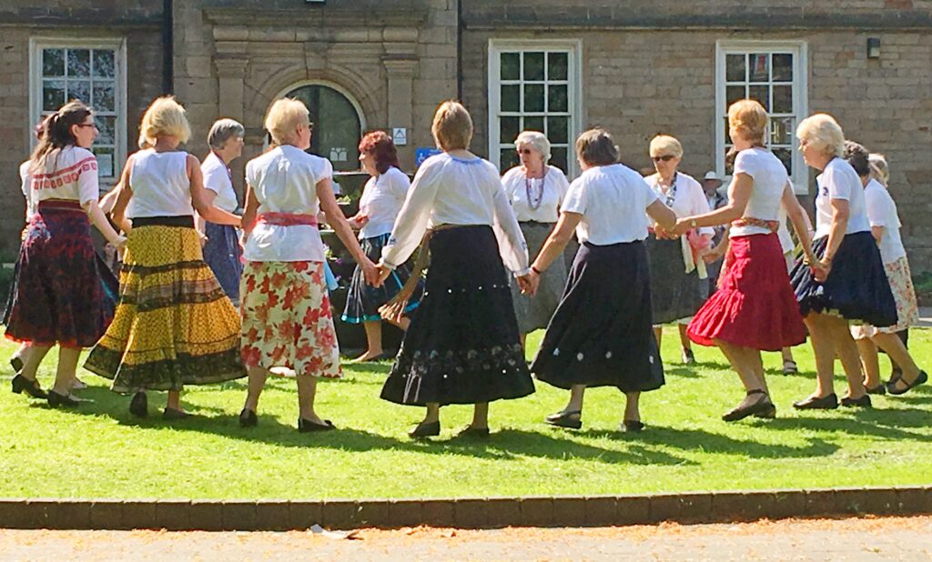 a group of folk dancers in traditional costumes