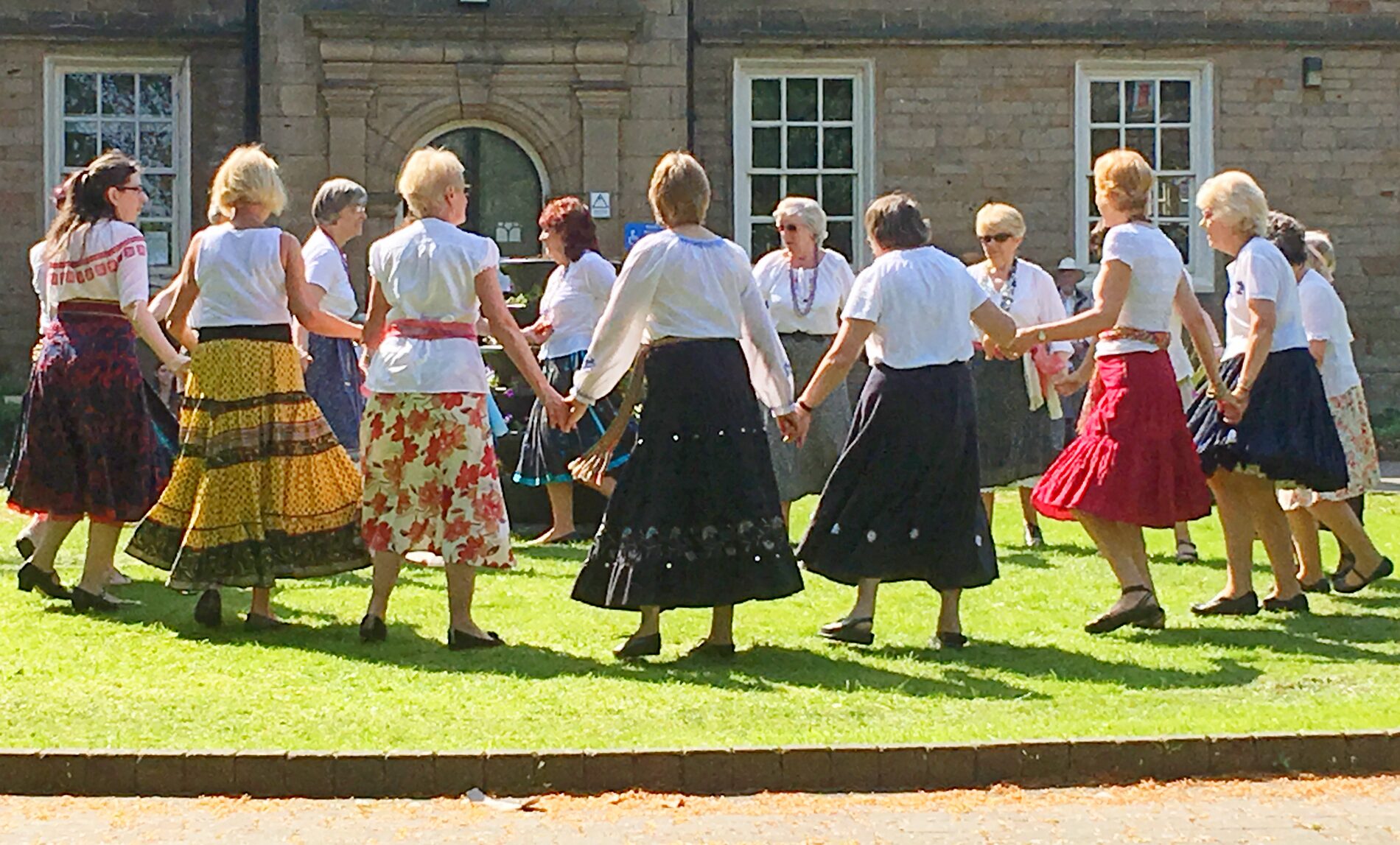 a group of folk dancers in traditional costumes