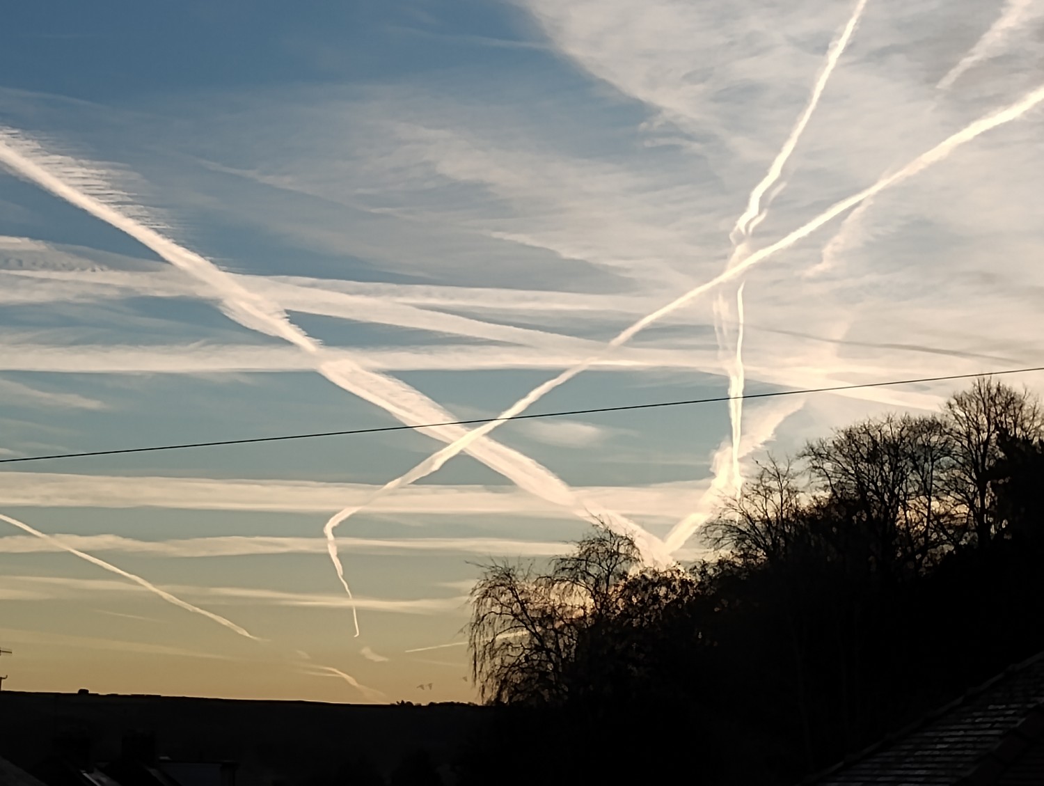blue sky with many contrails