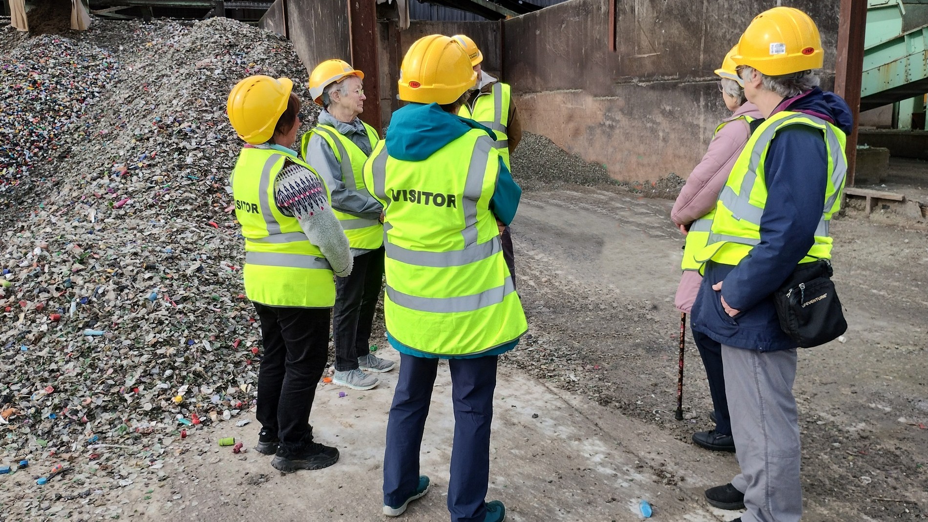 a group of people wearing hivis jackets and hard hats