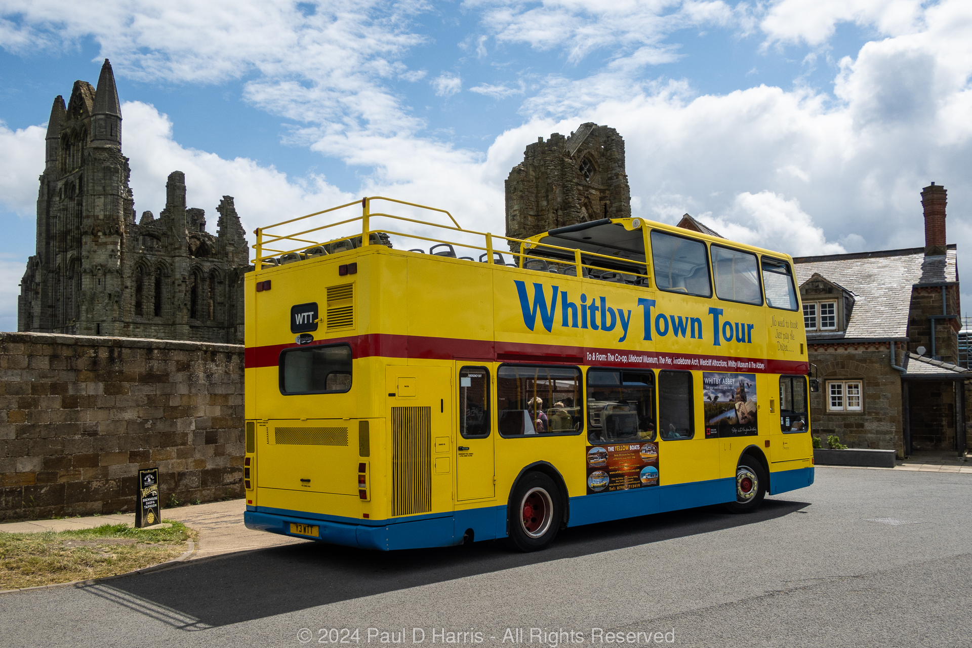 Open-top bus sightseeing tours, seen here up at Whitby Abbey