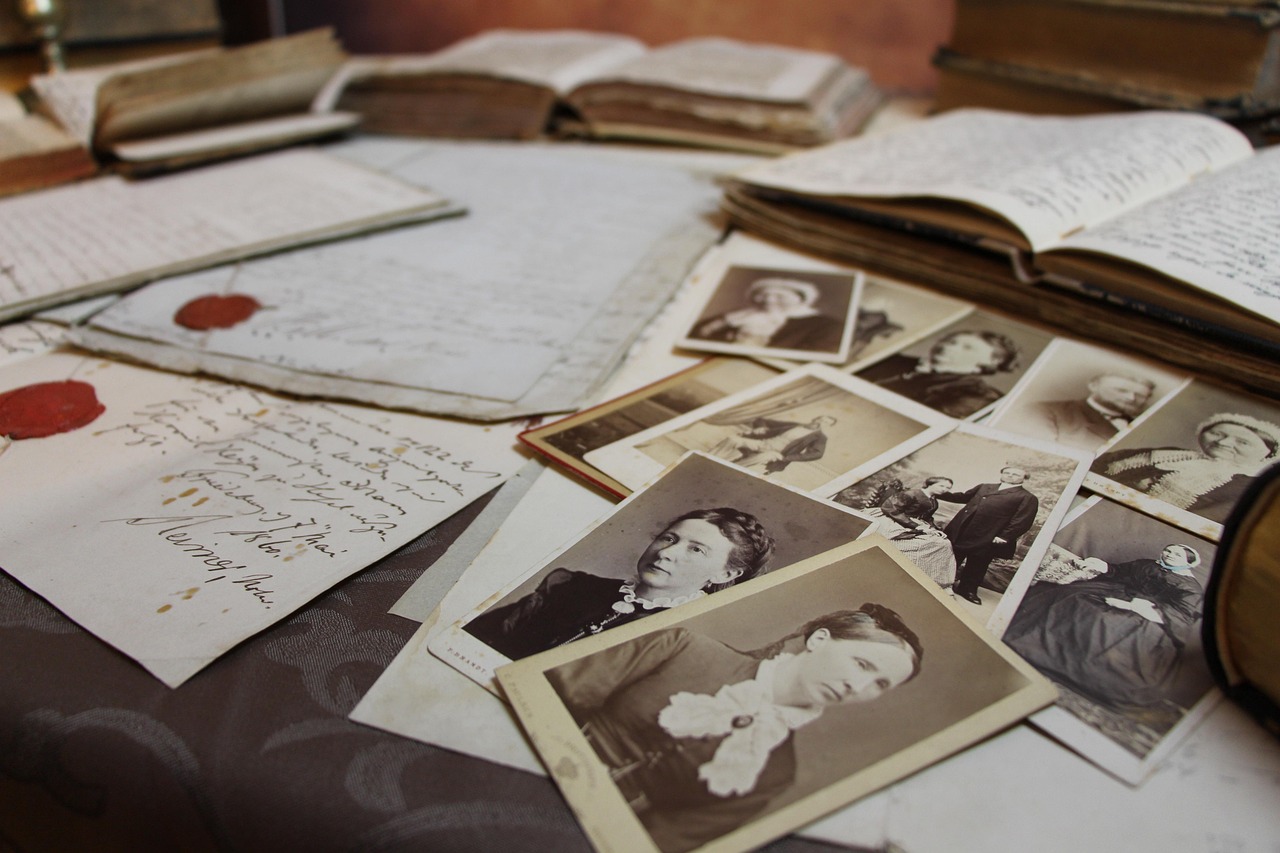 a collection of old photos and documents on a table